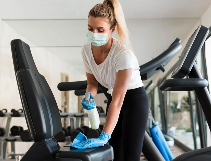 Commercial cleaner performing cleaning in gym