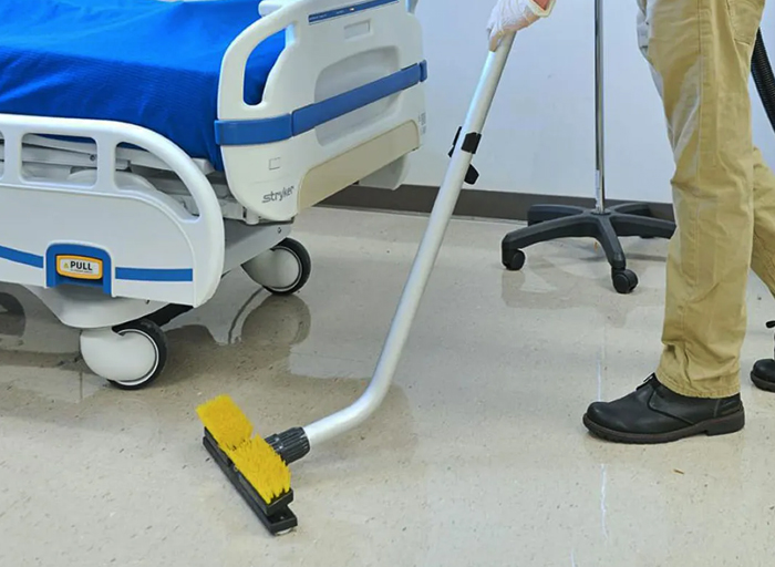 Medical centre cleaning team disinfecting a treatment room